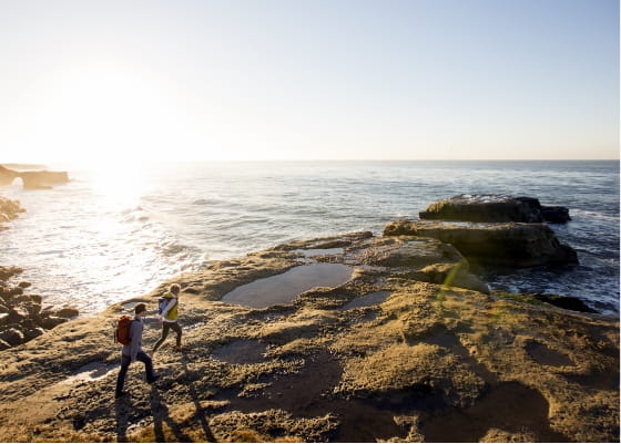 couple hiking the california coast