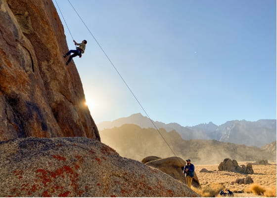 woman learning to climb in a beautiful mountain